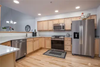 Generous kitchen has been updated with newer quartz counters and stainless appliances