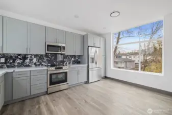 This kitchen showcases the lay out and high-quality finishes you can expect in the newly constructed home at 8608 & 8610 42nd Ave S, Seattle, WA 98118, built by the same builder.