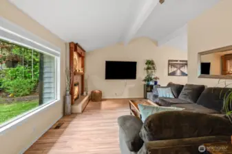 Large picture window and vaulted ceilings.