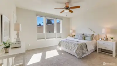 The primary bedroom is spacious with a ceiling fan and a walk-in closet.