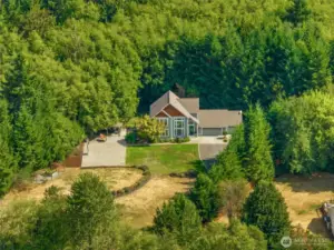 Very private setting, tucked back on the 1.25 acre lot. It will once again have views of the Olympics once the trees across the street are cut again.