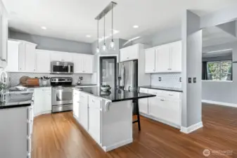 Stunning kitchen with large island, granite countertops and walk-in pantry