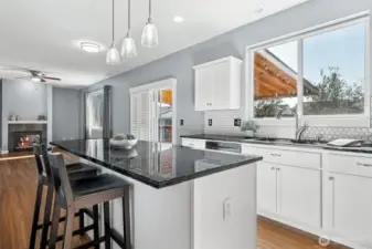 Cook's dream kitchen with large island with granite coutertops and walk-in pantry.