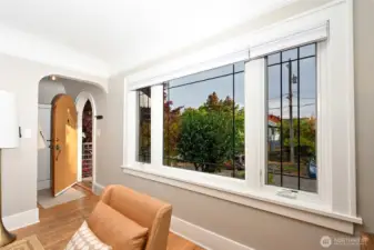 Entry has big windows and hardwood floors.