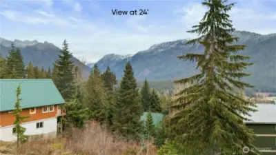 At twenty-four feet—your main living level—the landscape becomes panoramic. The valley pulls farther into view, the ridgelines become more defined. This is where great rooms, kitchens, and dining spaces turn into front-row seats for nature’s show.