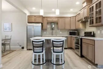 Beautiful maple cabinets, quartz countertops and tile backsplash.