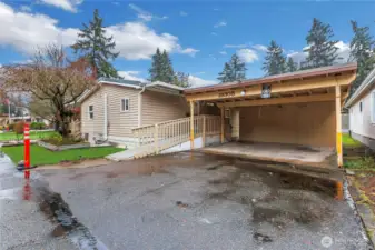 Back of home, easy access and covered parking for two cars.