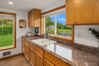 Plenty of countertop space and sink found in laundry room.