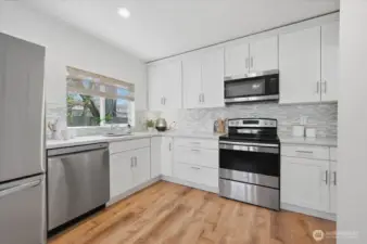 Nice size kitchen updated in 2017 with new cabinetry, quartz counters and Stainless steel appliances, though appliances (Fridge, Dishwasher & Garbage disposal have all been recently upgraded/replaced