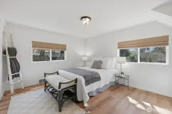 Light floods this nicely sized primary bedroom - bathroom just steps from the door