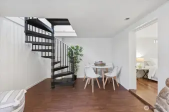 Showing how spiral staircase comes down into daylight basement with room under and around