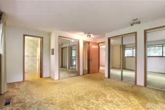 Primary bedroom with 4 (yes FOUR) closets.  The bath has a tub/shower combo.