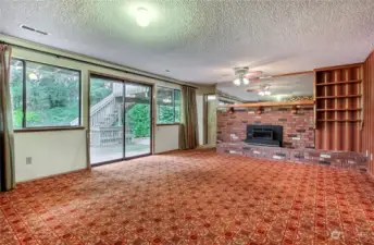 Family room opens to the large private back yard.  The stairs lead to the large deck off the formal dining room.