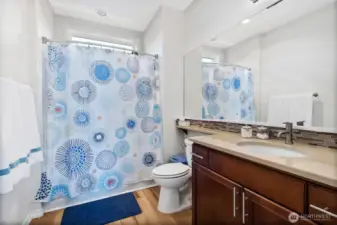 Bathroom portion of the 2nd en-suite bedroom. Consistent with the rest of the home, this full bath has been updated with water-proof luxury plank flooring.