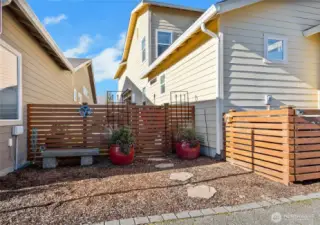 Even the back of this home is precious - fully fenced and landscaped with beautiful planters, pavers, and turf.