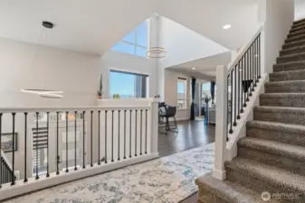 Stepping up from the entrance to the living and dining room with oversized windows to take in the views.  Stairs to 3rd floor.