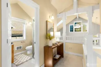 Nice railing overlook to the area below and 3/4 bath of the upstairs primary bedroom