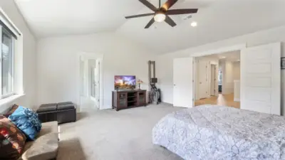 Step through charming French doors into the primary suite, featuring convenient en suite bathroom access