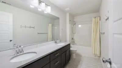 Guest-ready full bath upstairs featuring a double vanity for added comfort