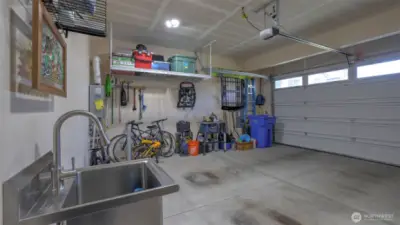 Roomy garage perfect for vehicles, gear, gatherings, and equipped with a handy sink
