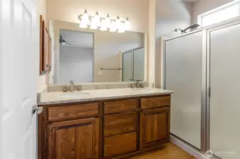 Primary bath has oversized walk-in shower, double sinks, and private toilet area.