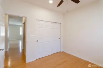 Another view, showing hallway into main living area and full bath adjacent on the left.