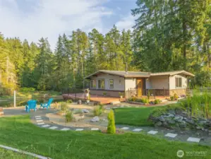 Beautiful waterfront home with easy to maintain landscaping that feels like you're in your own private park. Lots of areas for entertaining or just enjoying the conversation areas for yourself. This home also includes a buildable lot across the street that has been transformed into another private park for your enjoyment