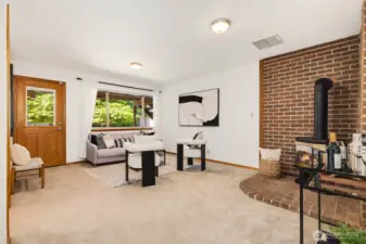 Large downstairs family room, complete with fireplace and backyard access