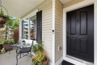 Relax and enjoy serene views from the covered front porch.