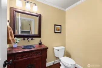 Powder room features an antique Asian cabinet.