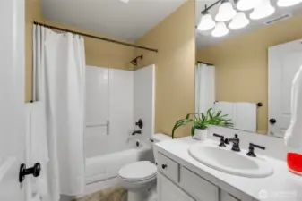 Main bathroom upstairs with bathtub and shower.