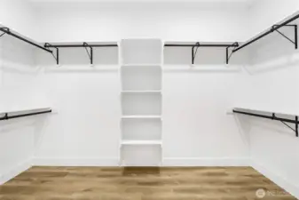 Functional and spacious primary closet design offering ample storage and organization.