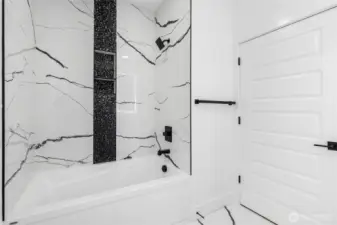 Full bathroom example with tile surround tub/shower and durable, modern finishes designed for everyday use.