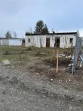 The East property marker near the fence in the back of the property.