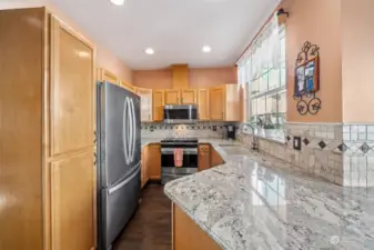 Updated kitchen with lots of counter space and plenty of cabinets too. Large sink with a garbage disposal.