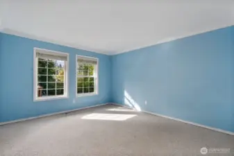 Bedroom number three with views to the rear yard and deck