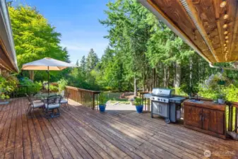 What a great deck! You will spend your summers back here, enjoying BBQs, or just relaxing in the privacy of your own park-like back yard