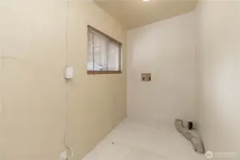 Laundry room adjacent to livingroom.