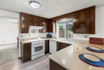Updated over the years, the kitchen offers great countertop space for meal prep and appliances are included. The window looks out over the fully fenced rear yard.