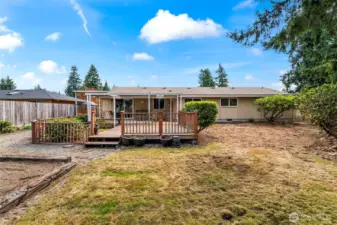 Large, fully fenced backyard with garden space to the left.