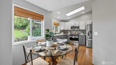 Start your mornings with coffee in this sunlit breakfast nook overlooking the yard.