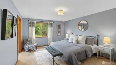 Wake up to lush green views from this tranquil primary suite.