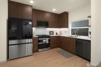 Sleek, modern kitchen with high-end appliances, designer cabinetry, and ample counter space.