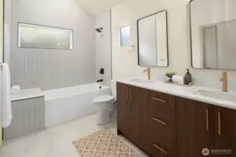 Bathroom also includes a full tub and stylish designer tile work