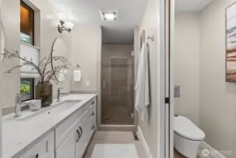 Updated primary bath with closable door for the toilet allows for added privacy.