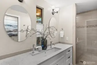 Dual faucets and mirrors and ample storage in this updated primary bath.