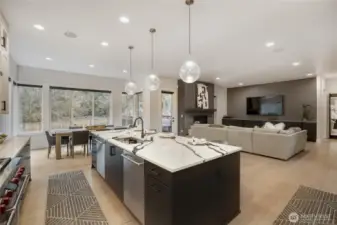 This designer kitchen blends modern elegance with everyday functionality. An expansive island with seating for five anchors the space, complemented by rich wood accents, sleek white cabinetry, and wide-plank flooring. A professional-grade Wolf range with a statement hood, Sub-Zero refrigerator, and built-in wine cooler elevate both style and performance. Bright, inviting, and impeccably finished, it’s the perfect setting for cooking, gathering, and entertaining.