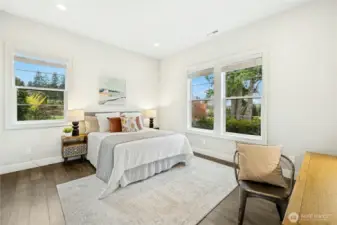 The main-level guest suite offers privacy and comfort with generous windows that invite natural light and peaceful garden views. Thoughtfully positioned on the main floor, this flexible space is ideal for guests, multi-generational living, or a private home office.