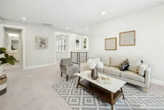 An alternate perspective showcases the generous scale of the bonus room and its open connection to surrounding bedrooms and bath. Soft carpeting and recessed lighting enhance the inviting ambiance, making this an ideal flex space for relaxation, recreation, or work.