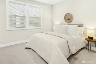 This additional perspective highlights the bedroom’s generous proportions and abundant natural light from dual windows. Soft carpeting, recessed lighting, and neutral tones create a serene retreat, while the layout easily accommodates a full or queen bed with space for nightstands and additional furnishings. A versatile room ideal for guests, household members, or a quiet workspace.